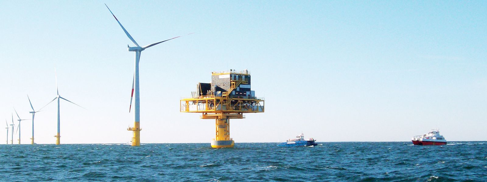 Triton Knoll offshore wind park with turbines and substation during sunny weather